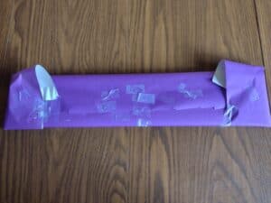 Picture of a present wrapped by a toddler