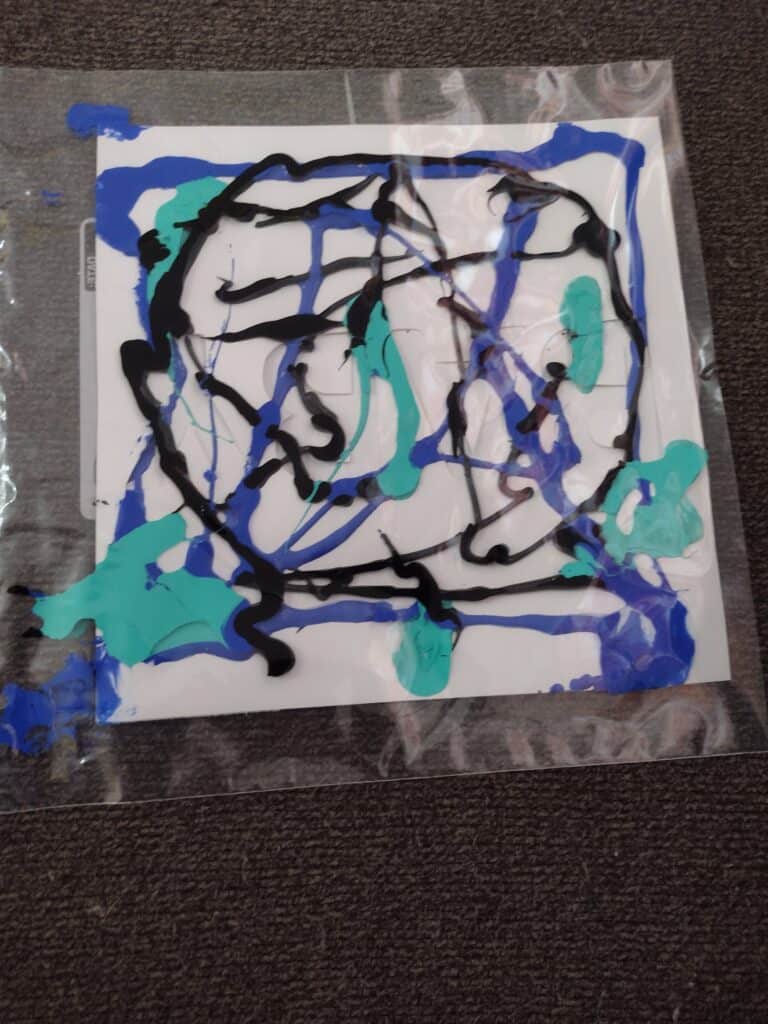 Picture of a bag containing paper with lots of paint on it
