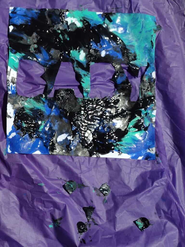 Picture of baby painting pieces drying on a tablecloth