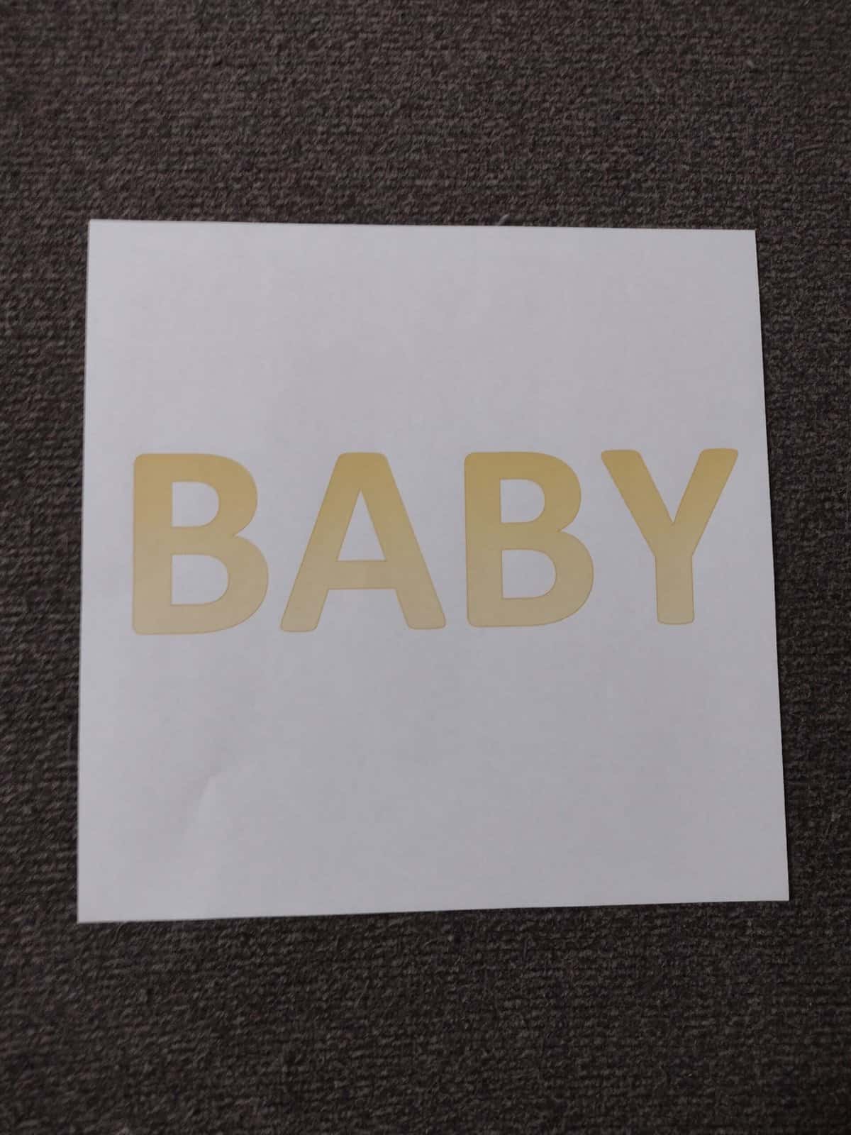 Picture of square paper with word "baby" printed on it