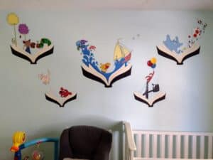 Picture of book themed mural painted on nursery wall