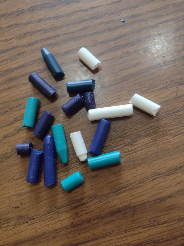 Picture of unwrapped crayons broken into pieces
