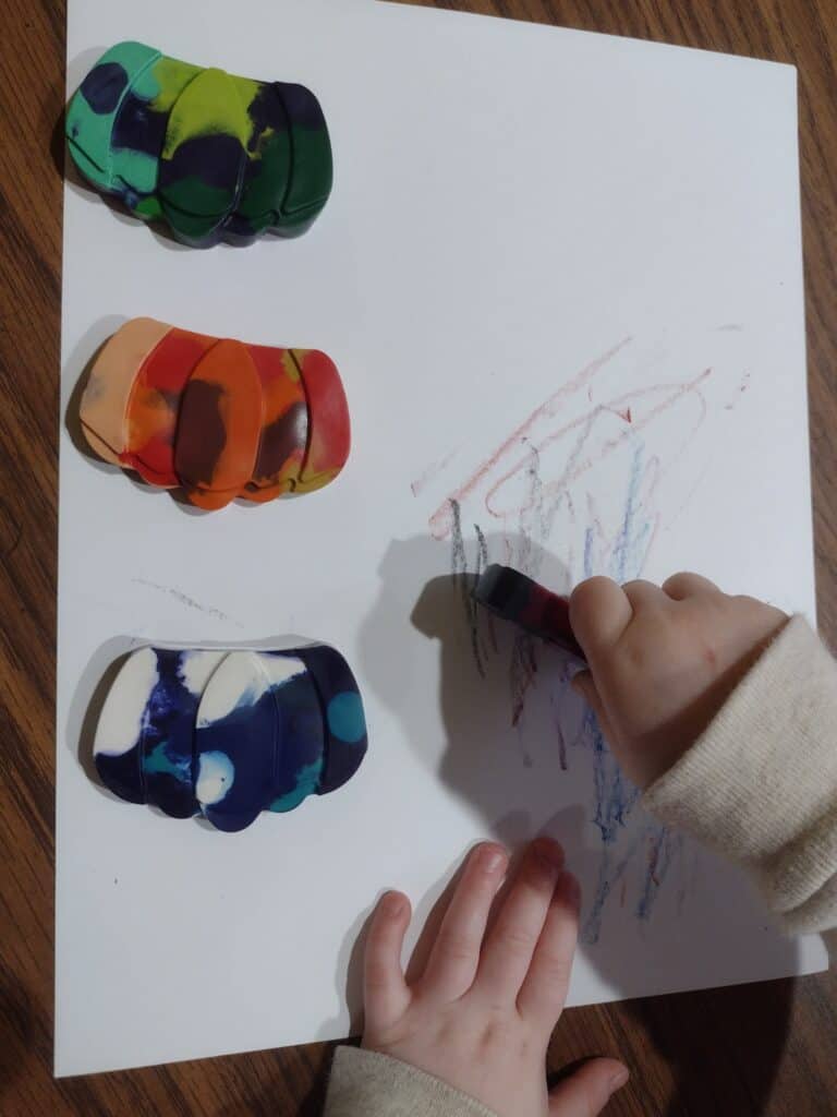 Picture of toddler coloring with crayons made by melting crayons in the oven