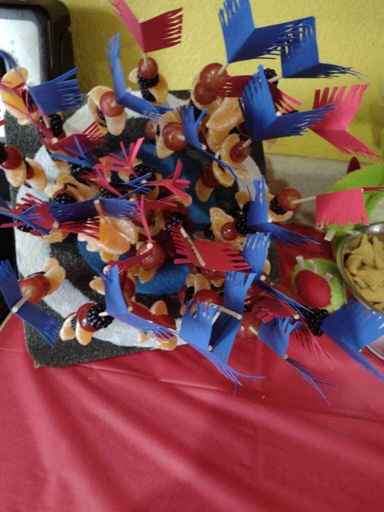 Picture of arrow shaped party fruit kabobs in a foam target