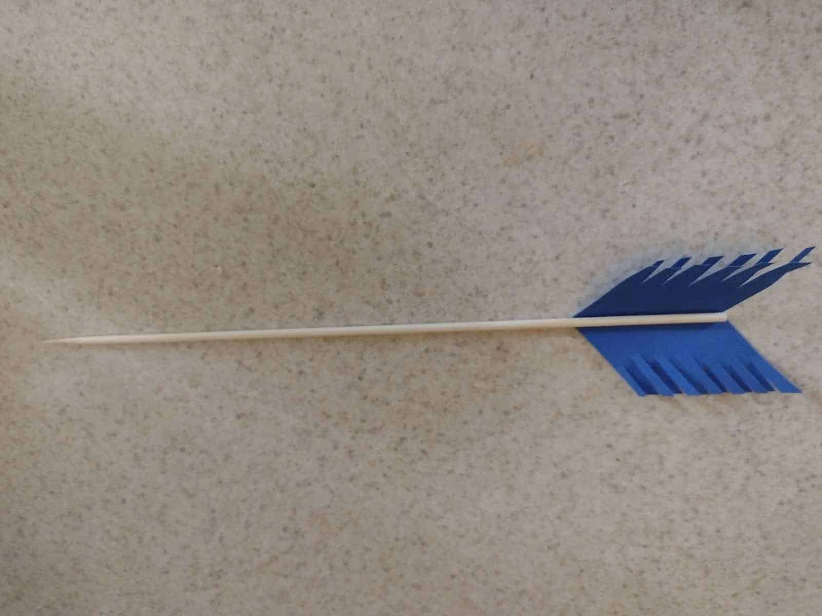 Picture of wooden skewer with arrow fletching shaped cardstock glued to the end and then cut to look feathery