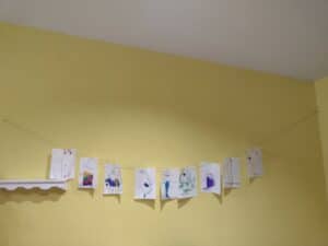 Picture of using a string clothesline to display your kid's art