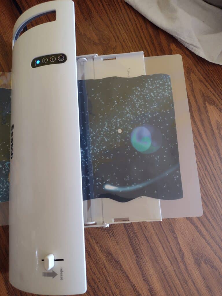 Picture of a space scene going through a laminator