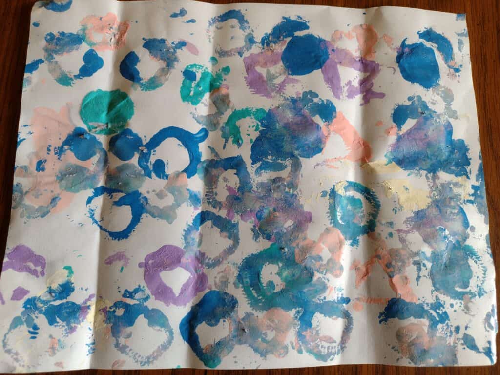 Picture of a piece of paper after a preschooler learned to paint with shapes using pipe cleaners
