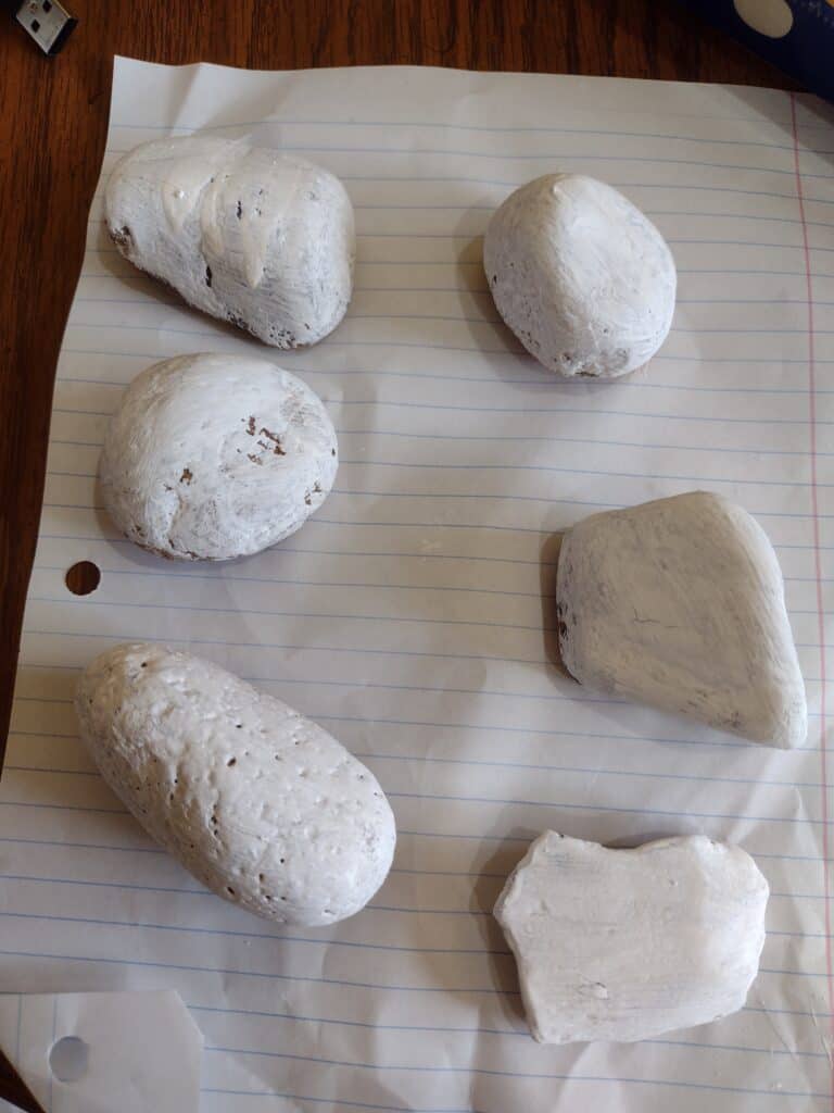 Picture of 6 white rocks painted with hydrochromic paint
