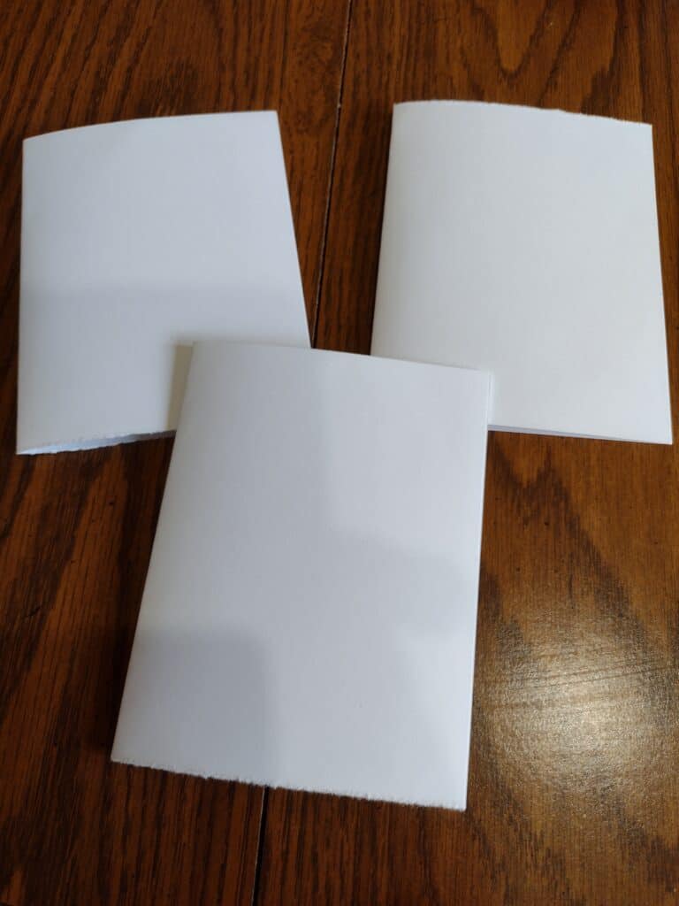Picture of three pieces of cardstock folded in half to form cards
