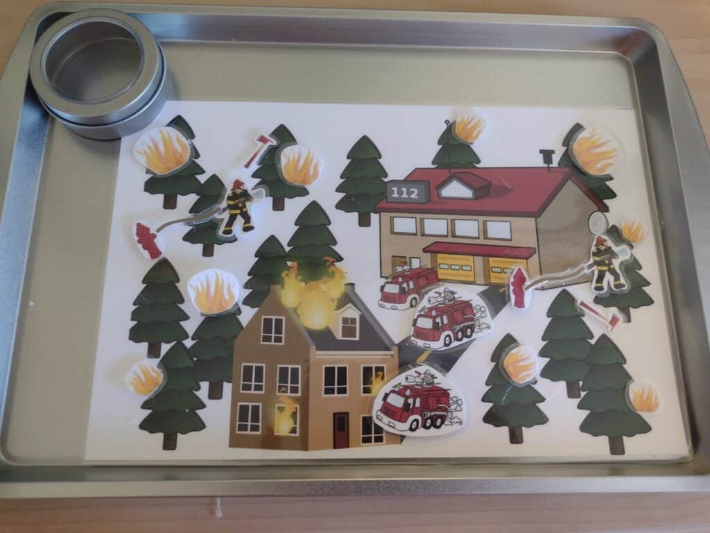 Picture of firefighter playmat with lots of firefighter themed pieces stuck to it