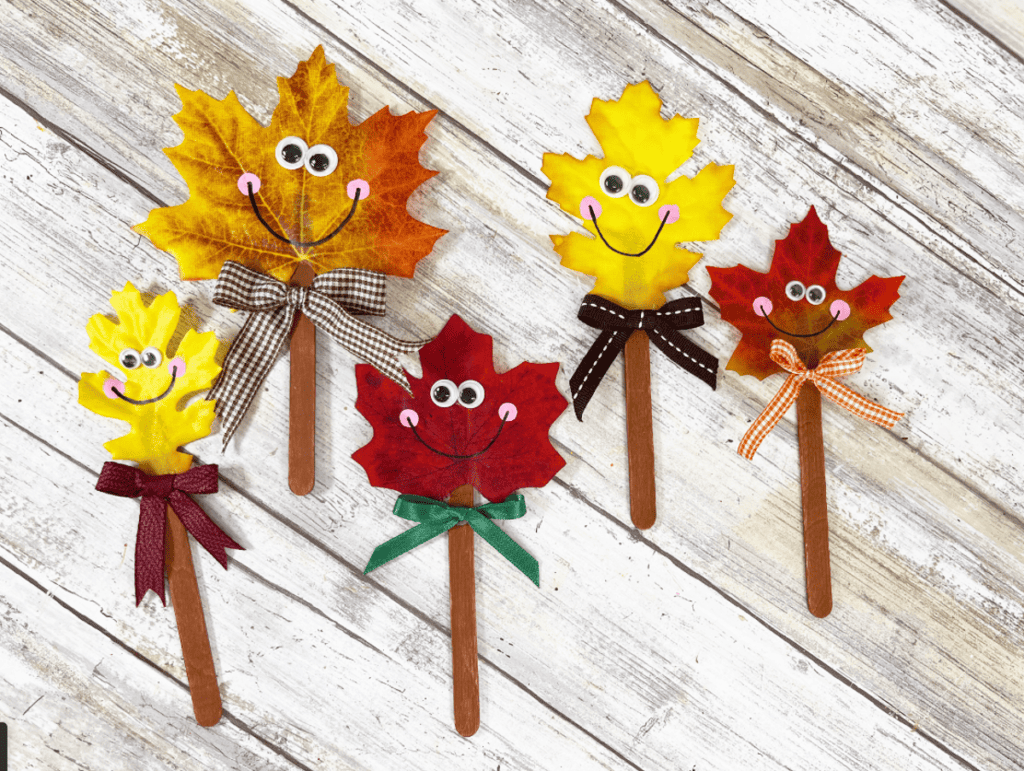 Picture of five leaf faces on popsicle sticks