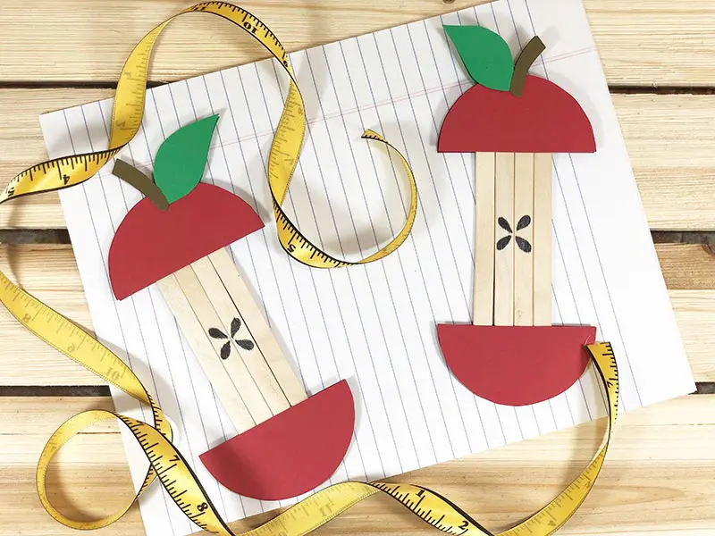 Picture of two apple popsicle stick crafts, The apple cores are made from popsicle sticks
