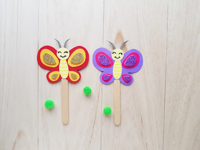 Picture of two butterflies glued to the end of popsicle sticks
