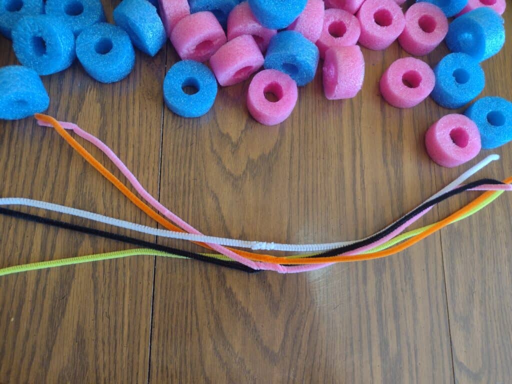 Picture of five pairs of pipe cleaners attached together. 