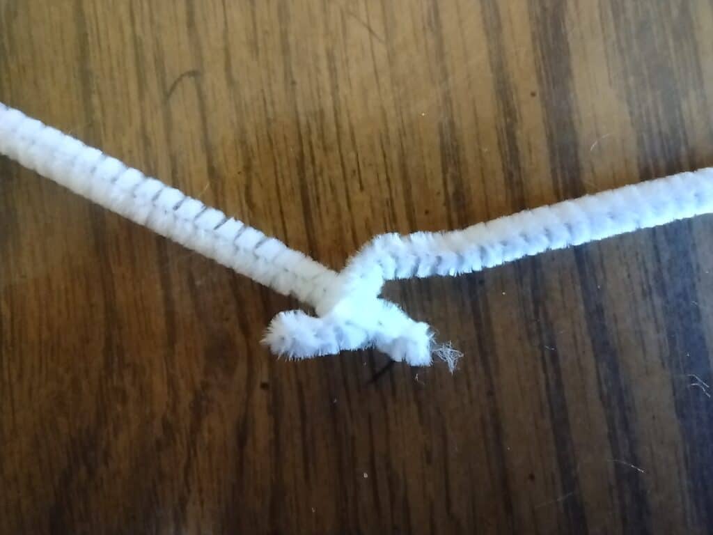 Picture of the ends of two pieces of pipe cleaner twisting around themselves