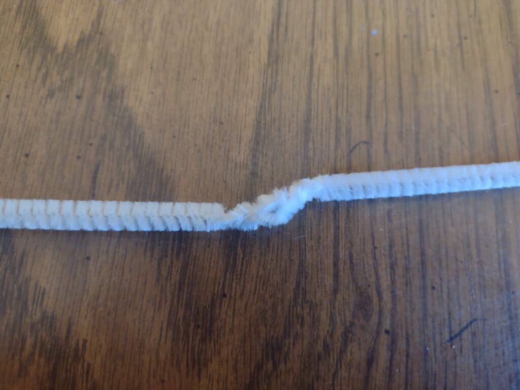 Picture of the ends of two pieces of pipe cleaner wrapped around each other and then folded back on themselves