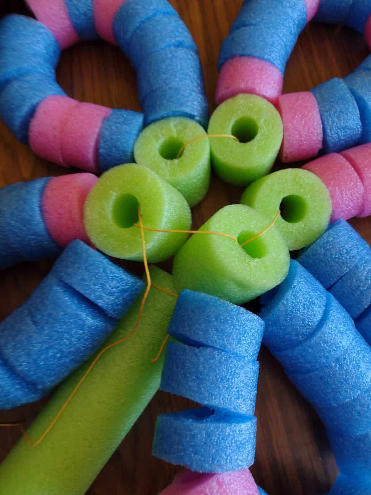 Picture of all five pool noodle petals threaded together on one side