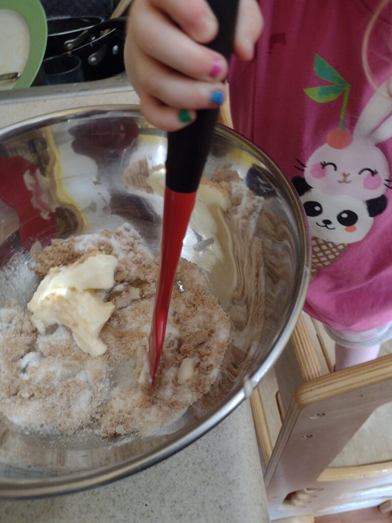 Picture of a preschooler stirring cookie dough