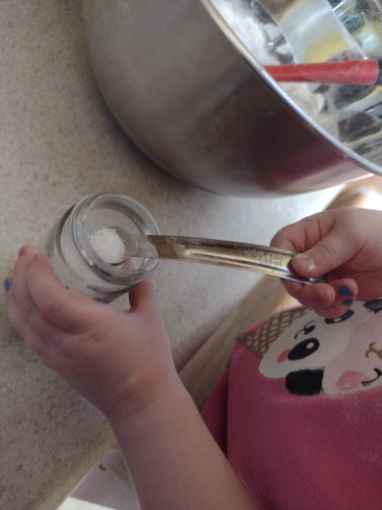 Picture of a preschooler measuring sea salt
