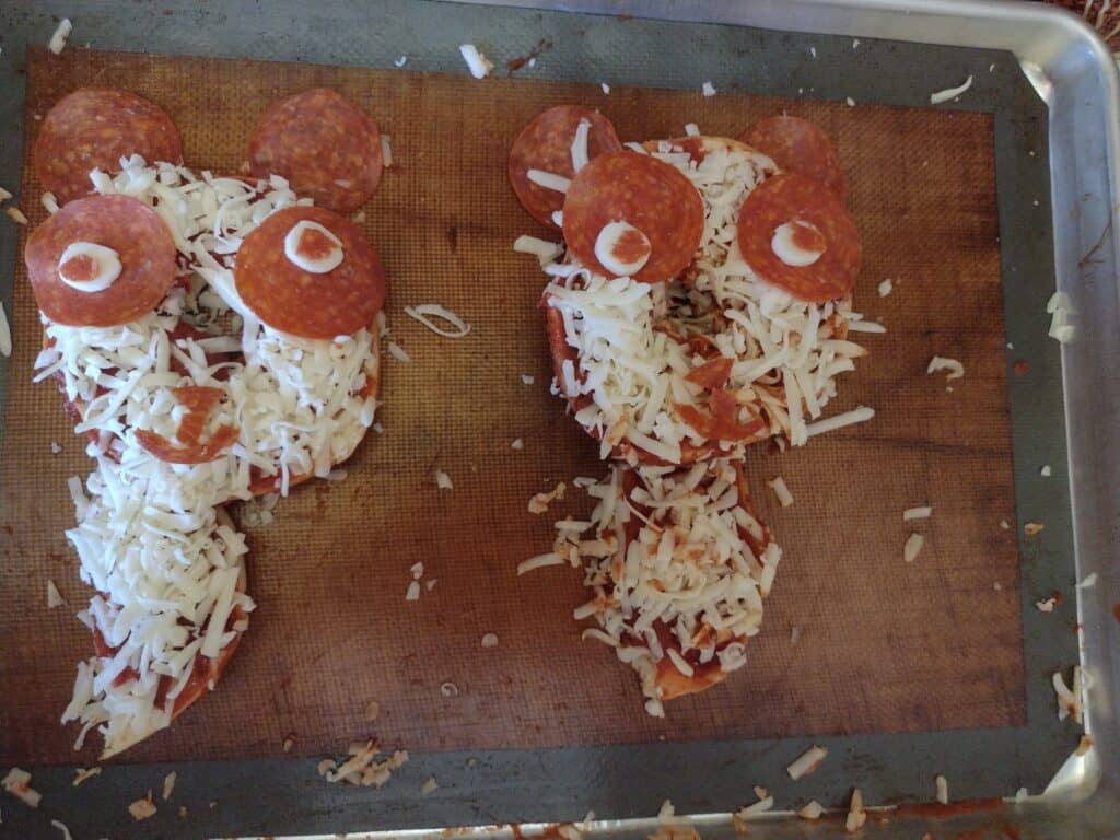 Picture of two pepperoni pizzas P is for panda craft about to go into the oven