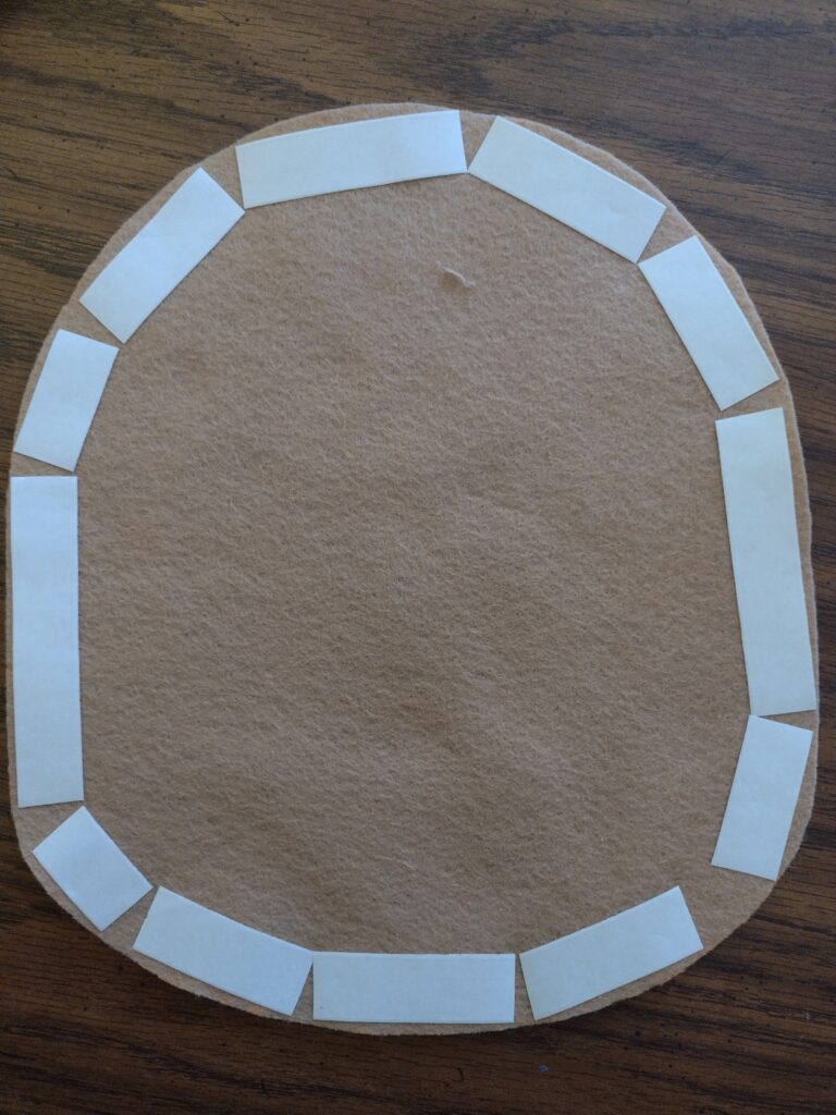 Picture of fabric tape on the back of a piece of brown felt