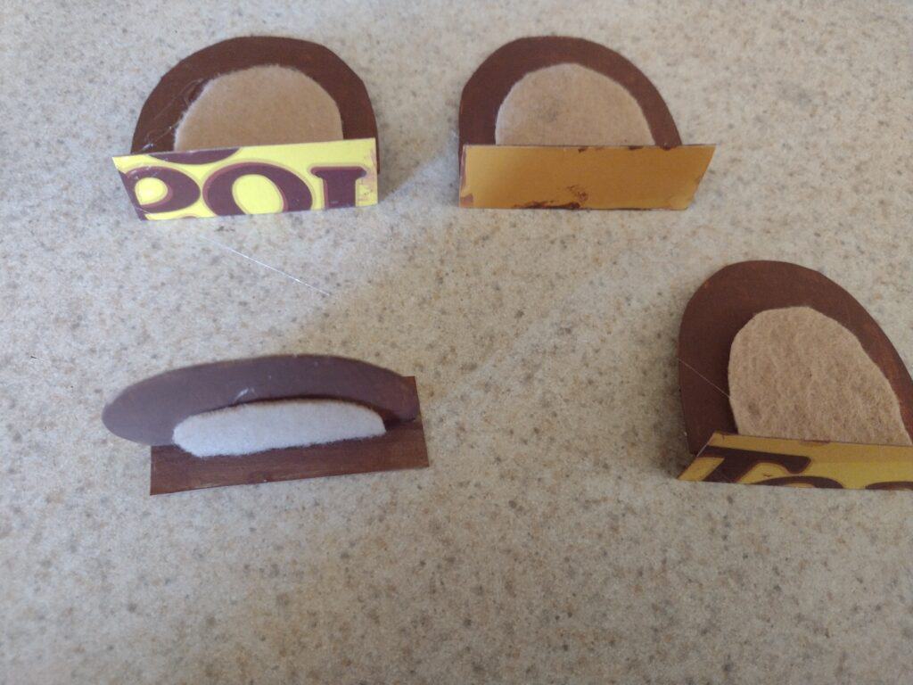 Picture of cardboard rectangles glued to the bottom of cardboard bear ears