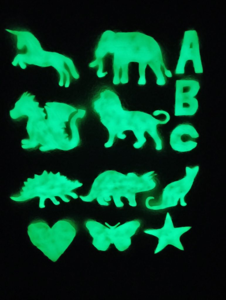 Picture of homemade glow in the dark stars and other shapes glowing in the dark